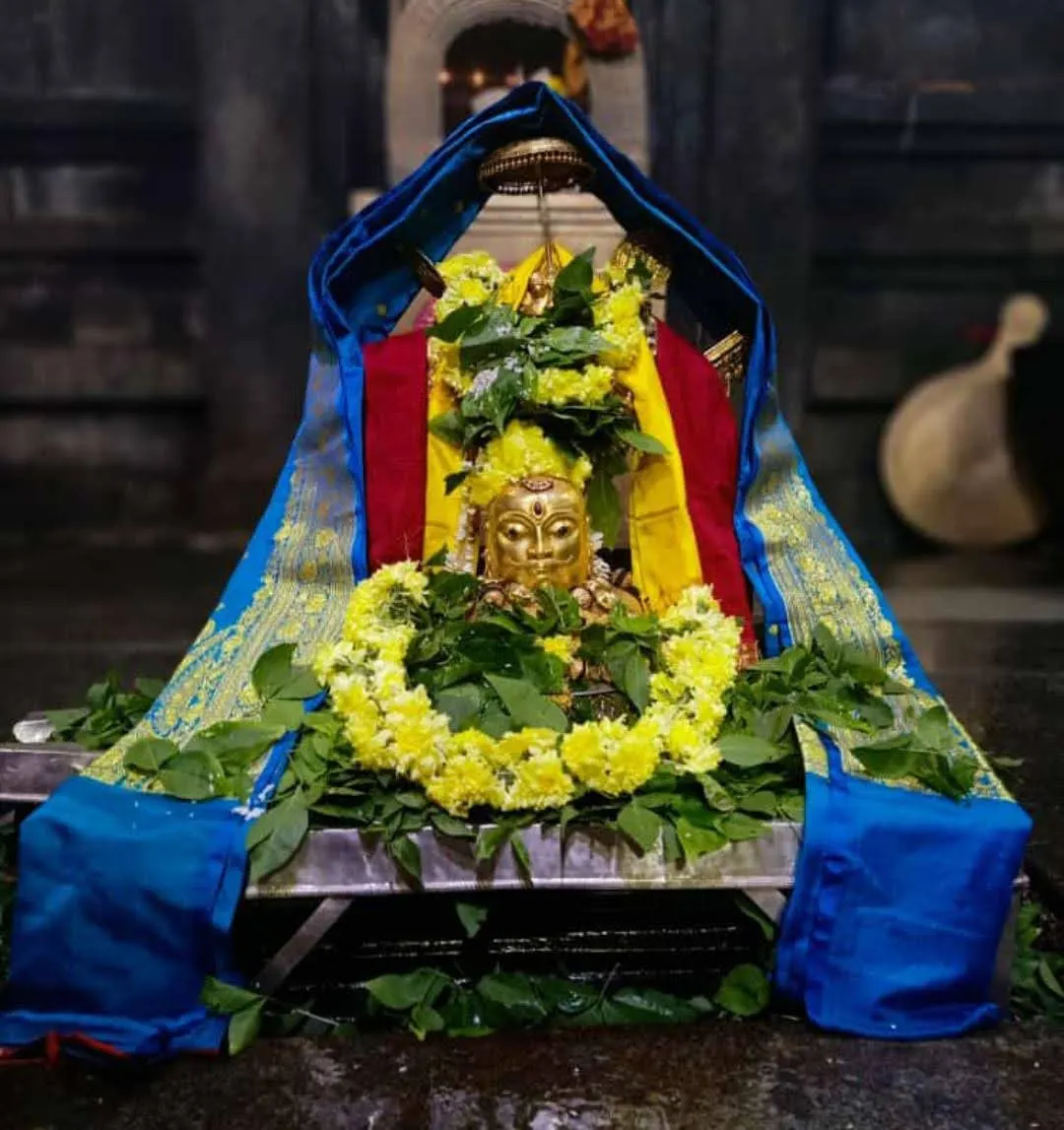 The deity dressed and garlanded for the rite